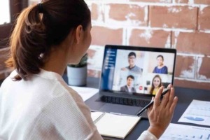 Woman in virtual meeting on laptop